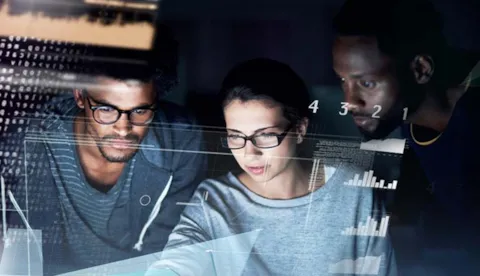 Three people looking at data