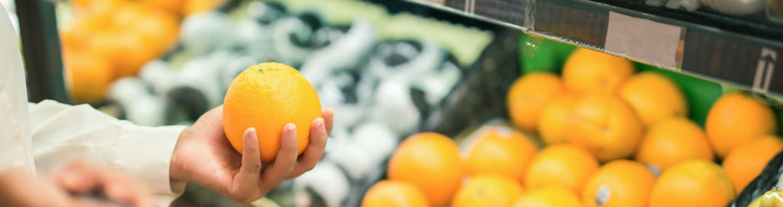 Hand reaching out for oranges