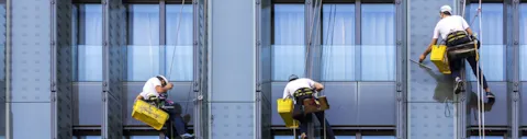 Workers outside skyscraper